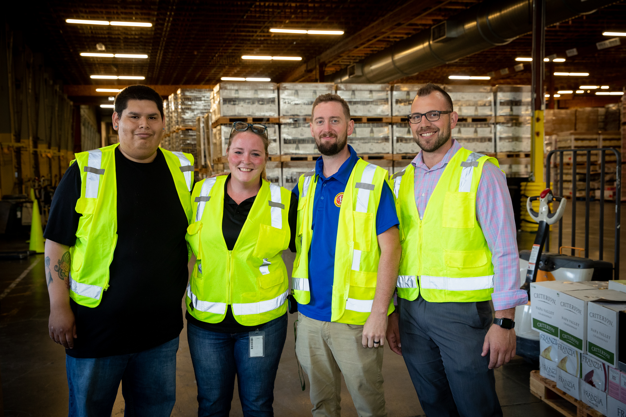 Four distribution center employees standing together